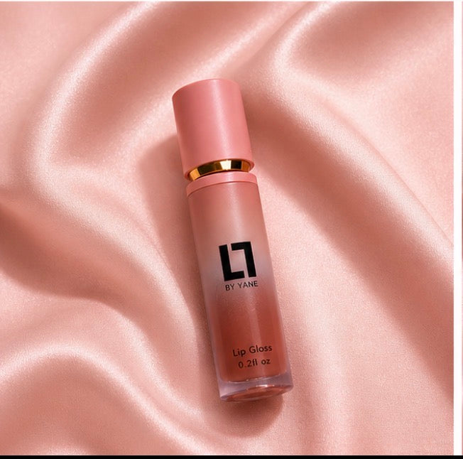 Lips and Lashes by Yane Lip Gloss in Desert Sand on pink satin