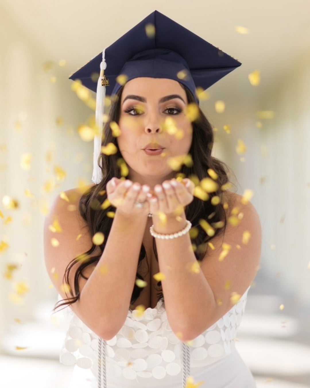 Graduation photo with gold confetti, makeup by Lips and Lashes by Yane