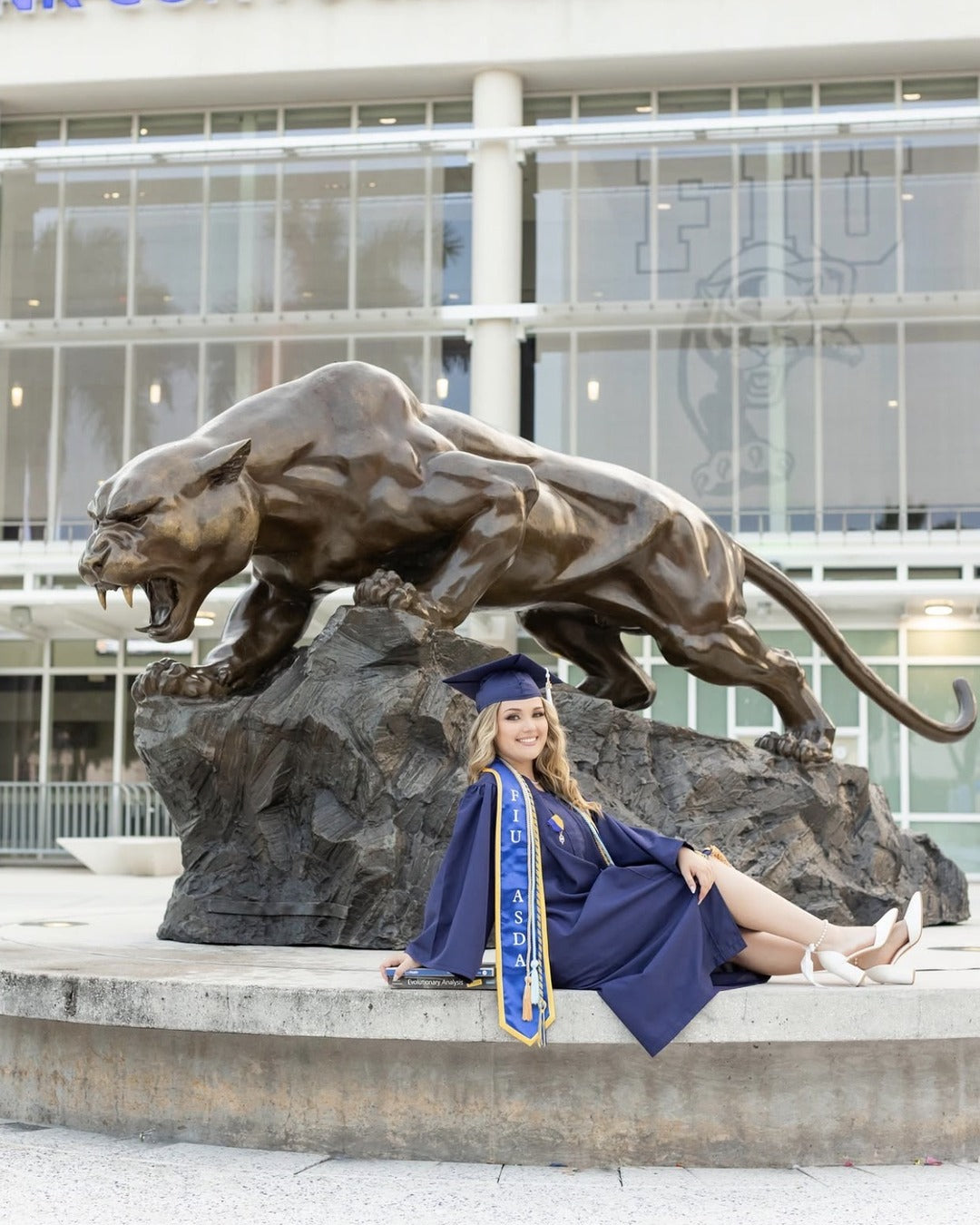 FIU graduation photo with the panther statue, makeup by Lips and Lashes by Yane