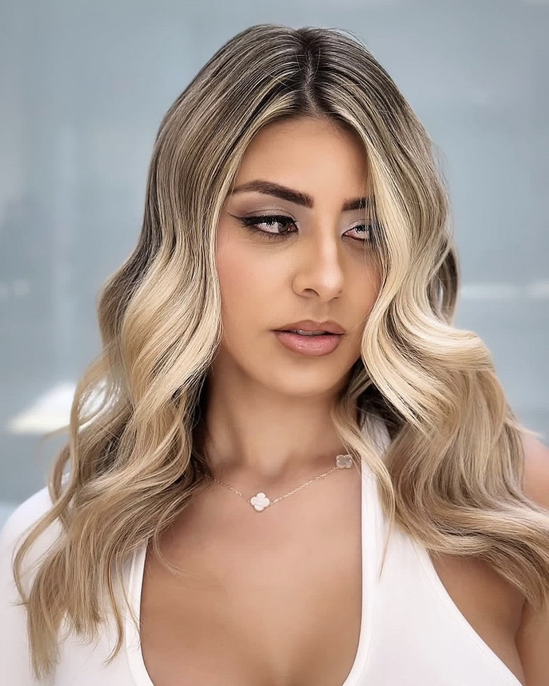 Blonde waves with soft winged liner and a nude lip in a white halter top, makeup by Lips and Lashes by Yane